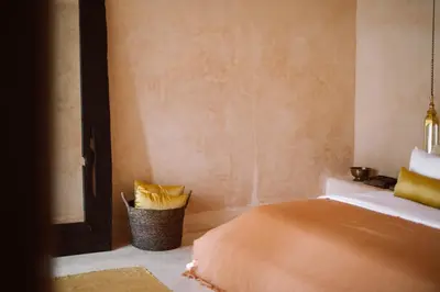a bedroom with a bed and a trash can at The Oasis Bali in Canggu