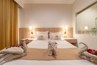 a bedroom with a bed with a stuffed elephant on it at The Hita Apartement in Seminyak