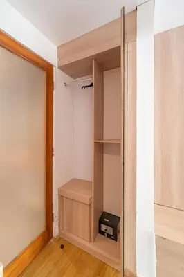 a room with a closet with a wooden door at The Hita Apartement in Seminyak