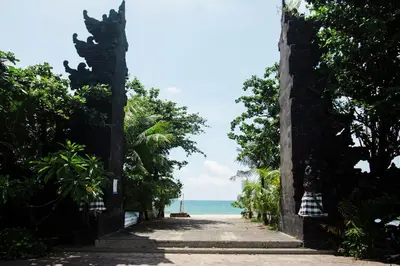 an archway leading to the ocean from the beach at Donguri House Bali in Jimbaran