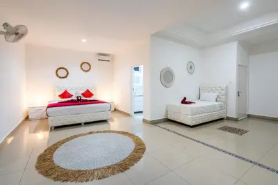 a large white room with two beds and a couch at Luxury minimalist villa White Angel in Seminyak, sleeps 21 people in total in Seminyak
