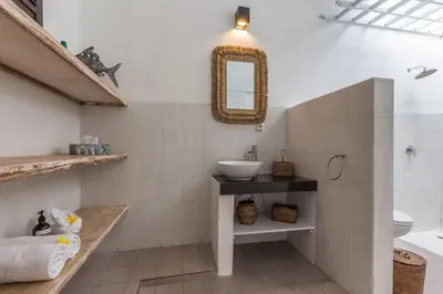 a bathroom with a sink and a mirror at Central & Charming 3bedr with private pool in Seminyak