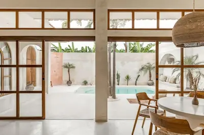 a dining room with a table and glass doors at NEW Design villa, Casa Alma Bali, 2BR with private pool in Canggu