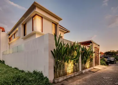 a house with a fence in front of it at Malinda Villa Seminyak in Seminyak