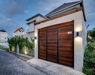a wooden garage door on a house at Malinda Villa Seminyak in Seminyak