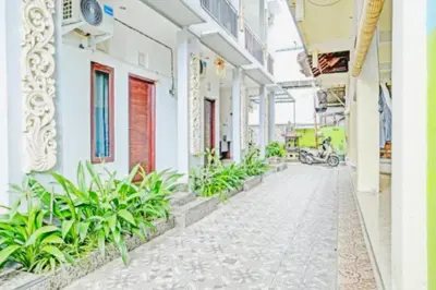 an empty corridor of a building with plants at Bali DD homestay seminyak in Seminyak
