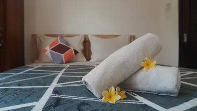 a bed with towels and flowers on top of it at Bali DD homestay seminyak in Seminyak