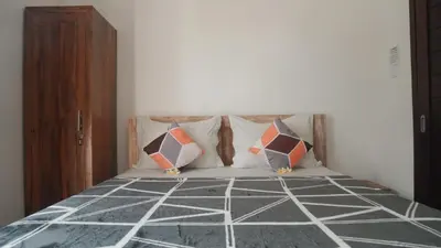 a bedroom with a bed with pillows on it at Bali DD homestay seminyak in Seminyak