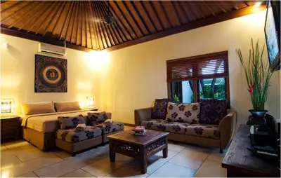 a living room with a bed and a couch and a table at 6BR Villa Sensel - Minggu Villas Seminyak in Seminyak