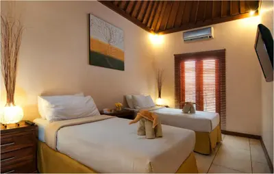 a bedroom with two beds with a teddy bear sitting on them at 6BR Villa Sensel - Minggu Villas Seminyak in Seminyak