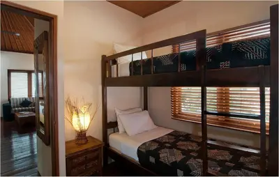 a bedroom with two bunk beds and a mirror at 6BR Villa Sensel - Minggu Villas Seminyak in Seminyak