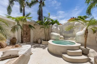 a pool in a resort with palm trees at Private Pool Villa Bocami Suites- 1 by OriVista in Kerobokan