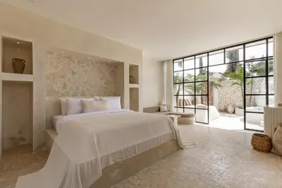 a bedroom with a large bed and a large window at Private Pool Villa Bocami Suites- 1 by OriVista in Kerobokan