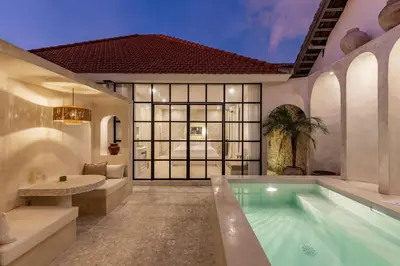 a pool in a house with a bedroom at Private Pool Villa Bocami Suites- 2 by OriVista in Kerobokan