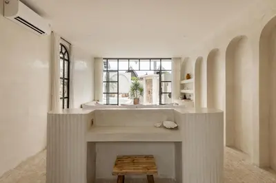 a living room with a fireplace and a table at Private Pool Villa Bocami Suites- 2 by OriVista in Kerobokan
