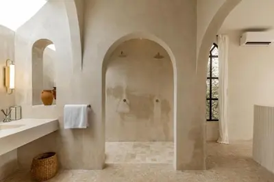 a bathroom with a shower and a sink and a mirror at Private Pool Villa Bocami Suites- 2 by OriVista in Kerobokan