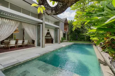 an external view of a villa with a swimming pool at Villa Deh Simba at Seminyak Aramanis in Seminyak