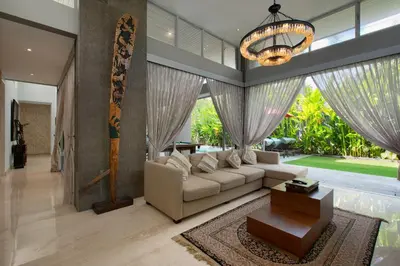 a living room with a couch and a chandelier at Villa Deh Simba at Seminyak Aramanis in Seminyak