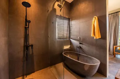 a bath tub in a bathroom with a shower at ZenBali 1 Villa Canggu in Canggu