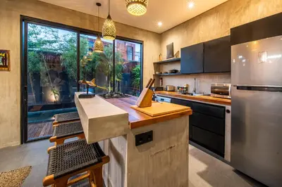 a large kitchen with a stainless steel refrigerator at ZenBali 1 Villa Canggu in Canggu