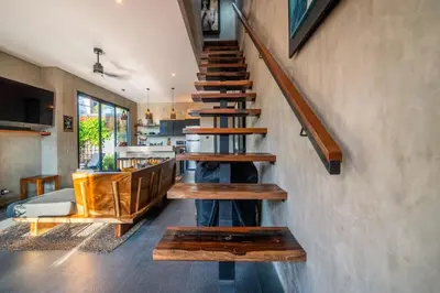 a staircase in a house with wooden steps at ZenBali 1 Villa Canggu in Canggu