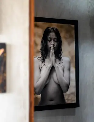 a shirtless woman in a picture of herself praying at ZenBali 1 Villa Canggu in Canggu