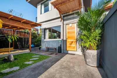 a house with a porch with a potted plant at ZenBali 1 Villa Canggu in Canggu