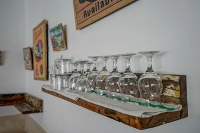 a row of wine glasses on a shelf on a wall at Villa Art Gecko, 2BR private haven in Heart of Batu Belig, Seminyak in Canggu