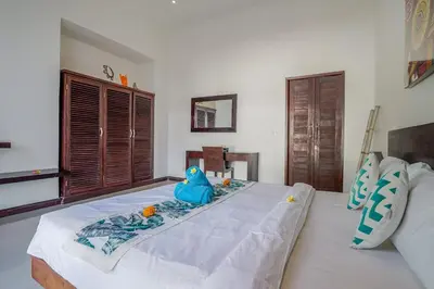 a bedroom with a bed with a blue object on it at Villa Art Gecko, 2BR private haven in Heart of Batu Belig, Seminyak in Canggu