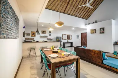 a dining room and kitchen with a table and chairs at Villa Art Gecko, 2BR private haven in Heart of Batu Belig, Seminyak in Canggu