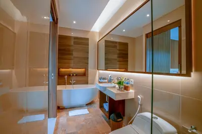 a bathroom with a tub and a sink and a toilet at Kahayana Seminyak Villa in Seminyak