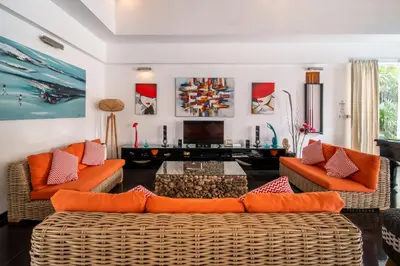a living room with two couches and a tv at Villa Kalamansi Seminyak in Seminyak