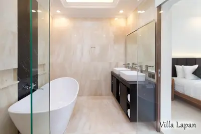 a bathroom with a tub and two sinks and a bed at Villa Mia Seminyak - Boutique Villas - II in Seminyak