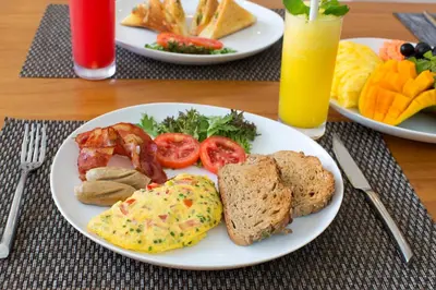 a table with two plates of breakfast food on it at Villa Mia Seminyak - Boutique Villas - II in Seminyak