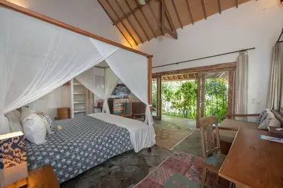a bedroom with a bed and a living room at Gorgeous Balinese Designed 3 Bed Villa, Top Pick! in Seminyak