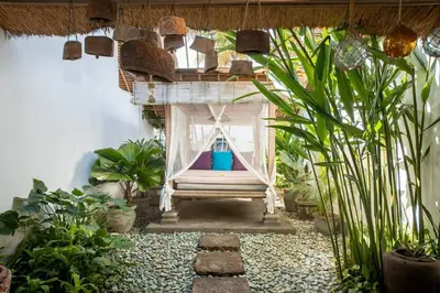 a garden with a hammock in a room with plants at Gorgeous Balinese Designed 3 Bed Villa, Top Pick! in Seminyak