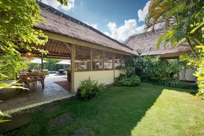 a house with a patio and a grass yard at Gorgeous Balinese Designed 3 Bed Villa, Top Pick! in Seminyak