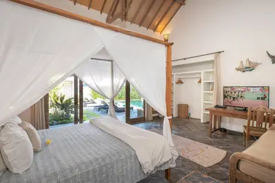 a bedroom with a canopy bed and a desk at Gorgeous Balinese Designed 3 Bed Villa, Top Pick! in Seminyak