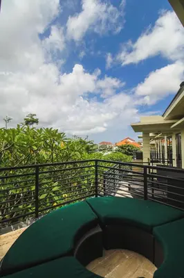 a green bench on a balcony of a house at Abisha Villa Jimbaran in Jimbaran