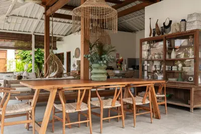 a dining room with a wooden table and chairs at Villa Folie by Alfred in Bali in Seminyak