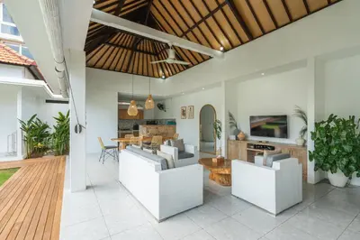 a living room with white furniture and a dining room at Modern 3 Bedrooms Villa Beach Walking Distance in Seminyak