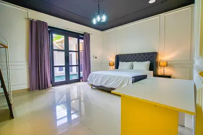 a bedroom with a bed and a desk in it at Villa Canberra - Seminyak in Seminyak