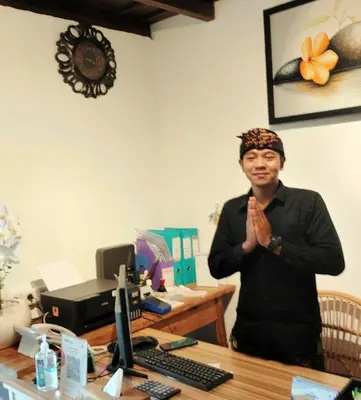 a man standing in front of a desk at Alam Jepun Villa in Legian