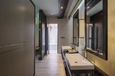 a bathroom with two sinks and a large mirror at INSPIRA Seminyak in Seminyak