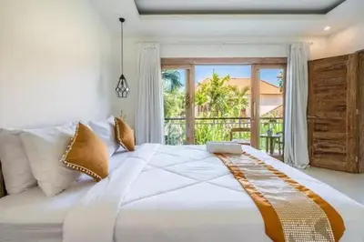 a large white bed in a bedroom with a window at NEW Villa Indah Seminyak 3BR Private Pool in Seminyak