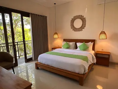 a bedroom with a large bed and a balcony at NEW Villa Indah Seminyak 3BR Private Pool in Seminyak
