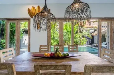 a dining room with a table with a bowl of fruit at NEW Villa Indah Seminyak 3BR Private Pool in Seminyak