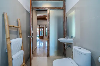 a bathroom with a toilet and a sink at Villa Kori Bali Kubu, 9 people maximum, close to Seminyak Beach in Seminyak