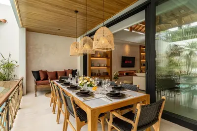 a dining room with a long table and chairs at Premium 5 bd Luxury Central Villa 300m to beach & Ku De Ta in Seminyak