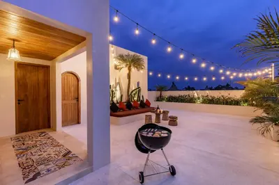a house with a chair in a room with lights at Premium 5 bd Luxury Central Villa 300m to beach & Ku De Ta in Seminyak